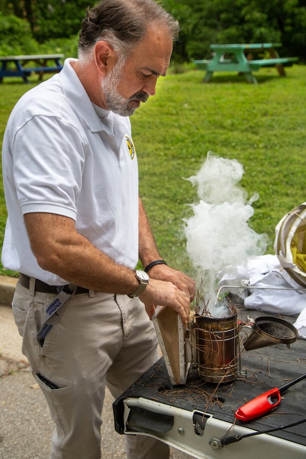 Tim Doherty prepares a smoker before checking on the bee hives at Mountain Way Common Park in Buckhead.  PHIL SKINNER FOR THE ATLANTA JOURNAL-CONSTITUTION.