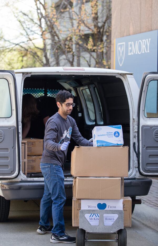 Third-year medical student Saumya Gurbani volunteers at Emory University Hospital moving donated medical supplies to its Materials Management Department on Monday. (Jenni Girtman for the Atlanta Journal-Constitution)