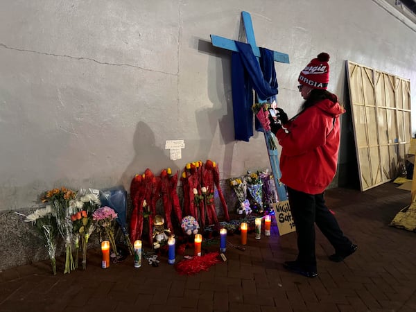 A Georgia football fan takes a photo of a memorial to victims of the deadly truck attack on Bourbon street after the area reopened, Thursday, Jan. 2, 2025, in New Orleans. (AP/Jack Brook)