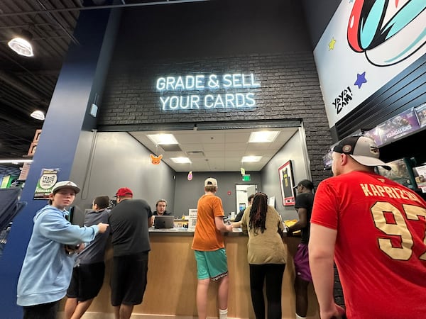 CardsHQ in Atlanta has nine employees who work with customers selling their card collections. RODNEY HO/rho@ajc.com