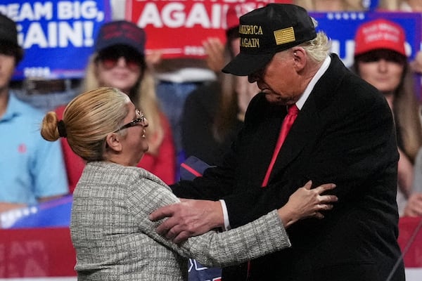 Carmen Ramirez, mother of Minelys "Mimi" Rodriguez Ramirez speaks with Republican presidential nominee former President Donald Trump after she endorsed the former president during a campaign rally at Atrium Health Amphitheater, Sunday, Nov. 3, 2024, in Macon, Ga. (AP Photo/Mike Stewart)