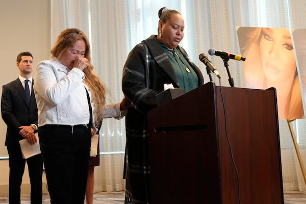 Adriana Vance, mother of Raymond Green who was killed in the Club Q nightclub mass shooting in Colorado Springs, Colo., talks about her son as grandmother Estela Bell, left, cries during a news conference announcing the filing of a civil complaint on the two-year anniversary of the deadly mass shooting, Tuesday, Nov. 19, 2024, in Denver. (AP Photo/Jack Dempsey)