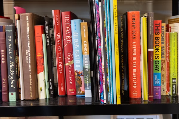 Banned and LGBTQ-related books are seen at Patricia Hill Hair Studio in Atlanta on Dec. 19. The salon aims to create a safe space for the LGBTQ+ community. Arvin Temkar/AJC