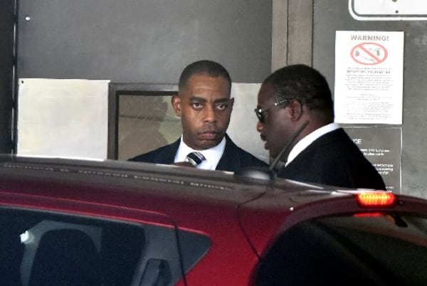 Atlanta’s former chief purchasing officer Adam Smith, left, leaves the federal courthouse in September after pleading guilty to accepting at least $30,000 in bribes. Federal prosecutors on Wednesday asked for leniency in Smith’s sentence. HYOSUB SHIN / HSHIN@AJC.COM