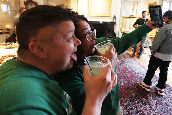 April Loh, left, and Marie Maia, take a selfie while enjoying a Kiwi Mule mocktail, made without tequila, during the sober Saint Patrick's Day celebration at the Whistler House Museum, Thursday, March 13, 2025, in Lowell, Mass. (AP Photo/Charles Krupa)