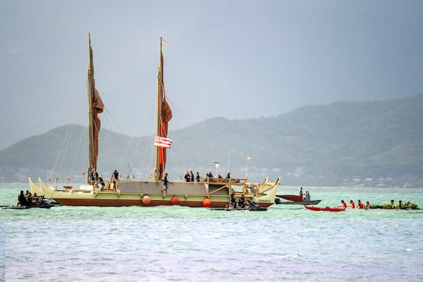 Kaneohe canoe club welcomes Hokulea as it arrives the shore of Kualoa Regional Park before Hokulea's 50th birthday commemoration, Saturday, March 8, 2025, in Kaneohe, Hawaii. (AP Photo/Mengshin Lin)