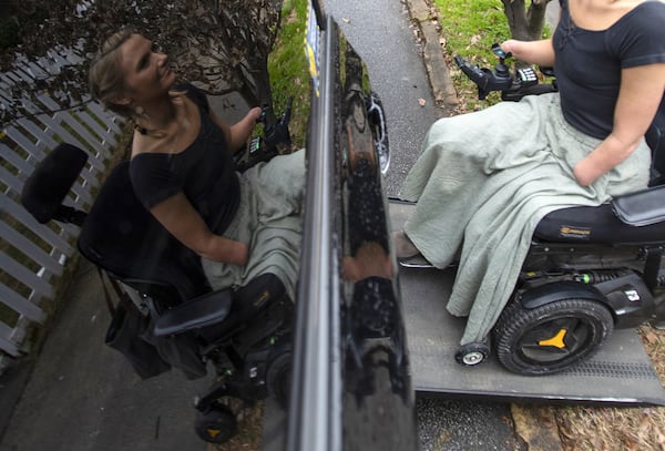 Aimee Copeland gets into her car using a ramp. Copeland, who lost her left leg, right foot and both hands to a flesh-eating bacteria after she cut her leg falling in a river from a zip line in 2012, uses her leg prosthesis to drive.