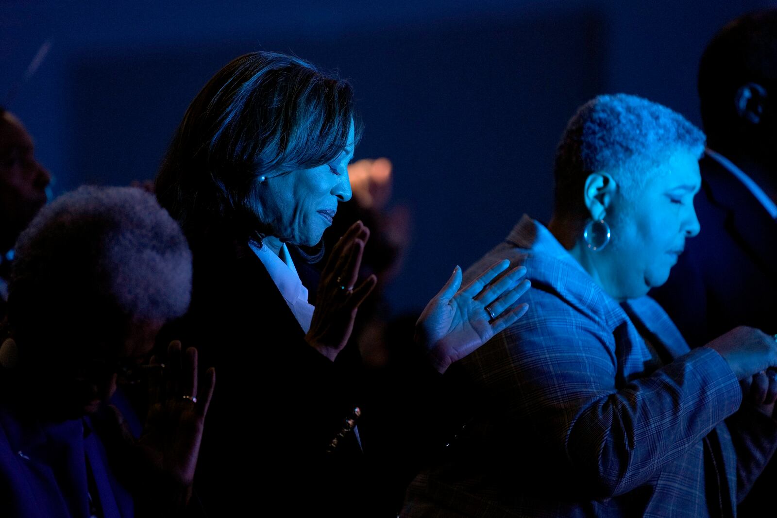 Democratic presidential nominee Vice President Kamala Harris, left, prays during a church service at Koinonia Christian Center in Greenville, N.C., Sunday, Oct. 13, 2024. (AP Photo/Susan Walsh)