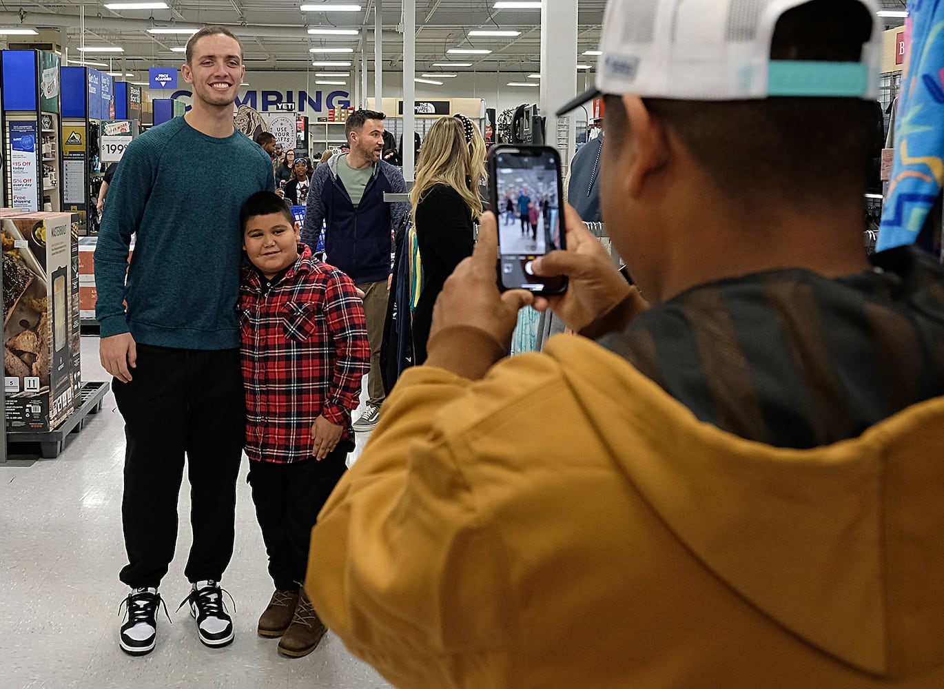 Fans stop Carson Beck in the store for autographs and photos while he was there shopping with the Athens area Boys and Girls club children. UGA Quarterback Carson Beck was on site at an Athen Academy store Sunday December 17, 2023, to give out gift cards to lucky members of area Boys and Girls Clubs. Academy Sports and Outdoors contributed $200 for each child and he kicked in $135 more of his own money to help families out. 

credit: Nell Carroll for the AJC