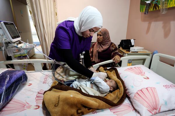 Palestinian infant Neven Abu Daqa, 6 months old, receives treatment at a hospital as the first group of sick children from Gaza arrives for medical care in Amman, Jordan, Tuesday, March 4, 2025. (AP Photo/Raad Adayleh)