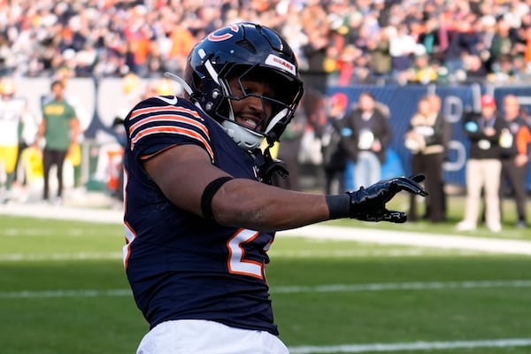 Chicago Bears' Roschon Johnson celebrates his touchdown run during the first half of an NFL football game against the Green Bay Packers Sunday, Nov. 17, 2024, in Chicago. (AP Photo/Charles Rex Arbogast)