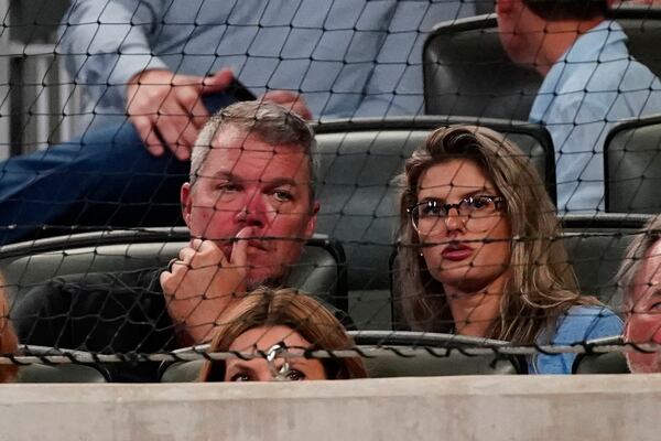 Former Atlanta Braves player and baseball Hall of Fame member Chipper Jones, left, and his wife Taylor watch a baseball game between the Braves and the Tampa Bay Rays, Saturday, July 17, 2021, in Atlanta. (AP Photo/John Bazemore)