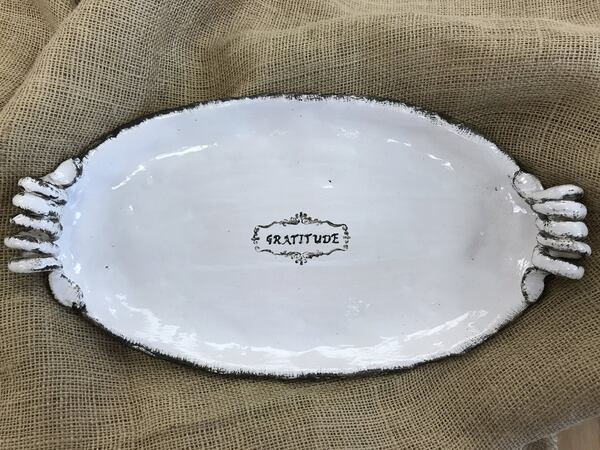 Alpharetta artist Lisa Rae Palmer creates platters, bowls and bakeware with an old-world look and a food-safe, lead-free glaze. She often adds designs or inspirational words (grateful is a favorite) to her work. CONTRIBUTED BY LISARAEDESIGN.COM