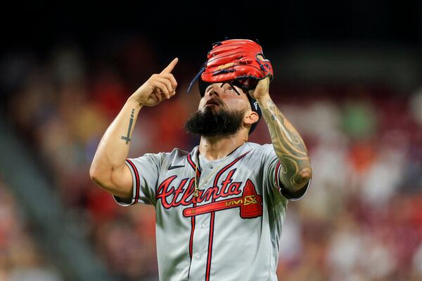 Atlanta Braves' Silvino Bracho points skyward after the final out of the team's baseball game against the Cincinnati Reds in Cincinnati, Friday, July 1, 2022. The Braves won 9-1. (AP Photo/Aaron Doster)