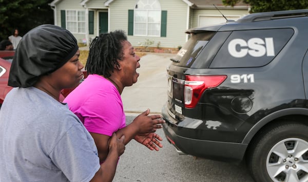 Teletha Walker (center) cried at the scene after learning of her son's death. JOHN SPINK / JSPINK@AJC.COM