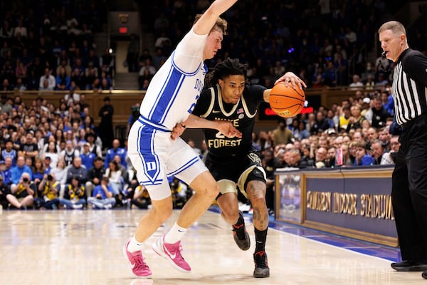 Wake Forest's Hunter Sallis, second from left, handles the ball as Duke's Cooper Flagg, left, defends during the first half of an NCAA college basketball game in Durham, N.C., Monday, March 3, 2025. (AP Photo/Ben McKeown)