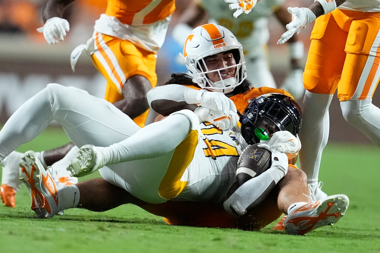 Tennessee linebacker Keenan Pili, left, tackles Kent State running back Curtis Douglas (24) during the first half of an NCAA college football game Saturday, Sept. 14, 2024, in Knoxville, Tenn. (AP Photo/George Walker IV)