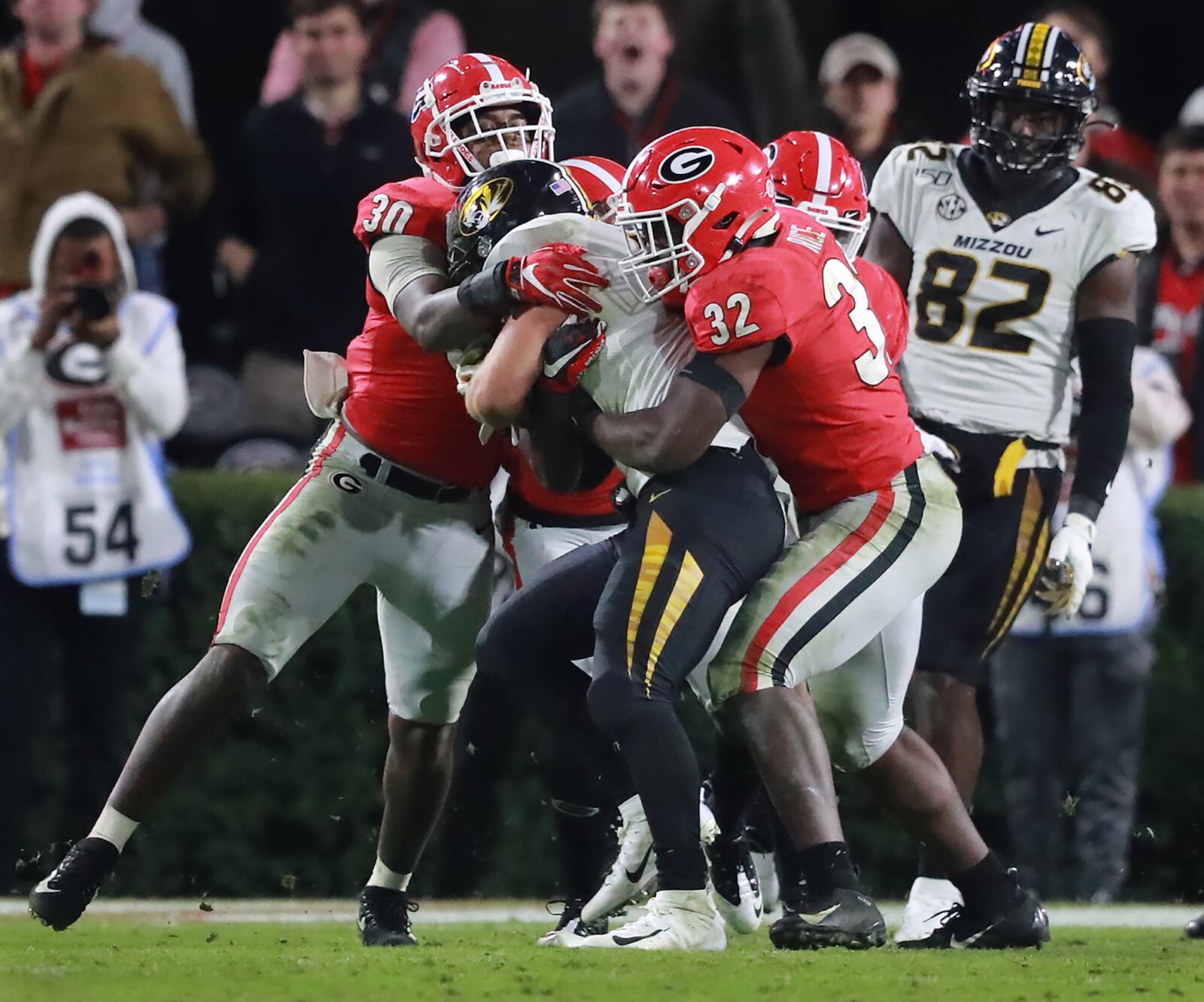 Georgia inside linebackers Monty Rice (right) and Tae Crowder (left) tackle Missouri running back Dawson Downing.   Curtis Compton/ccompton@ajc.com