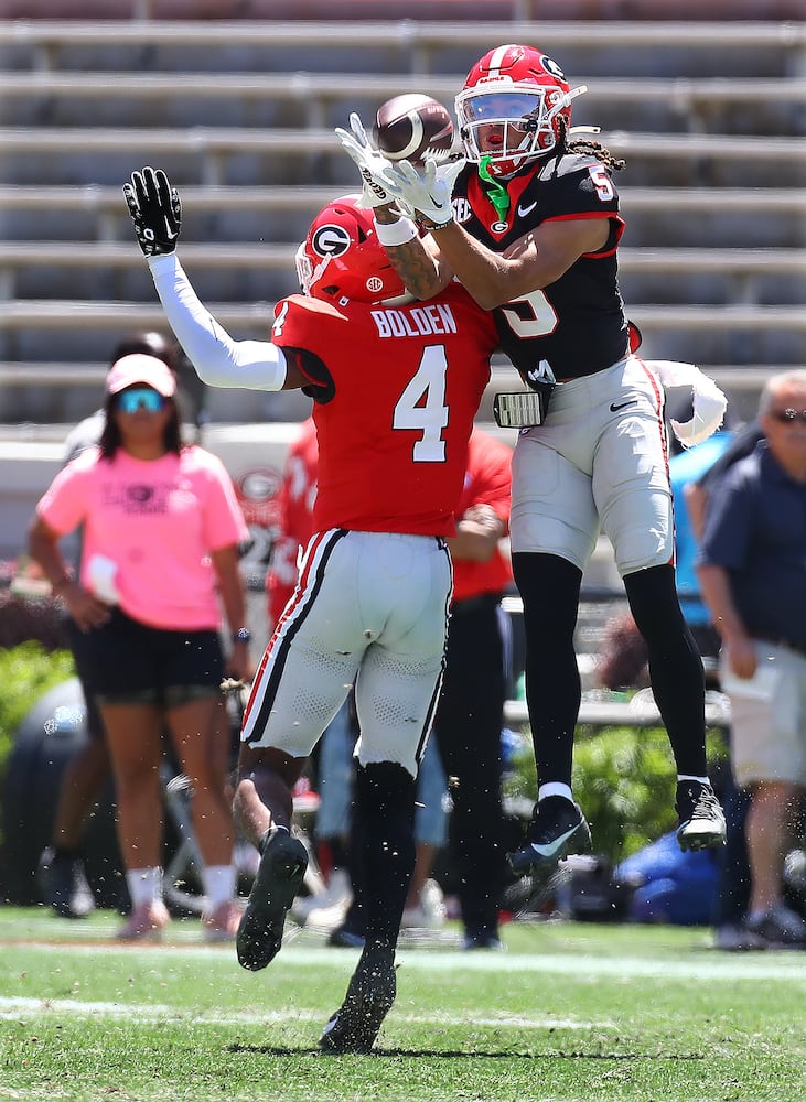 Wide receiver Anthony Evans III goes up for a reception over defensive back KJ Bolden for a long gain during the G-Day game on Saturday, April 13, 2024.  Curtis Compton for the Atlanta Journal Constitution