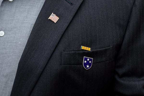 U.S. veteran Dan Hydrick wears a U.S flag pin, a Vietnam service pin, and an Americal Division pin on his jacket on Wednesday, November 2, 2022. (Natrice Miller/natrice.miller@ajc.com)  