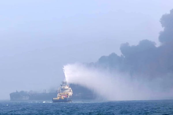 This image provided by Bartek Śmiałek shows a ship trying to extinguish the fire as smoke billows from a vessel after a cargo ship hit a tanker carrying jet fuel off eastern England on Monday, March 10, 2025 setting both ablaze and sending fuel pouring into the North Sea. (Bartek Śmiałek via AP)