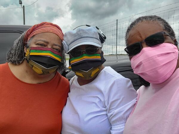 OCTOBER 9, 2020 — From left: Janice, Janese and Sheila Cockfield on a day trip to Carroll's Sausage & Country Store in Ashburn, Georgia, about 2½ hours from Atlanta. The twins Janice and Janese chose the country store as an ideal spot to rendezvous with Sheila, who drove 3½ hours to Ashburn from her home in Ormond Beach, Florida. Their colorful masks were made by another sister, Barbara Cockfield-Hill. (Credit: Sheila Cockfield / Contributed)