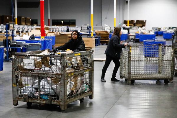 USPS employees sort packages in Henderson, Nevada. 