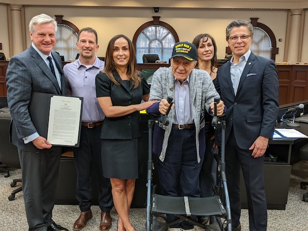 During a Roswell City Council meeting, Mayor Kurt Wilson presented Edward G. Bernard with a city proclamation naming him an “esteemed veteran of Roswell.” 
Bernard is standing with his walker. Also, pictured are Mayor Kurt Wilson, Joe Baker, Bernard's son-in-law; and the honoree's children, daughters Jeannette, Carmen and Edward A. Bernard. Photo courtesy City of Roswell.