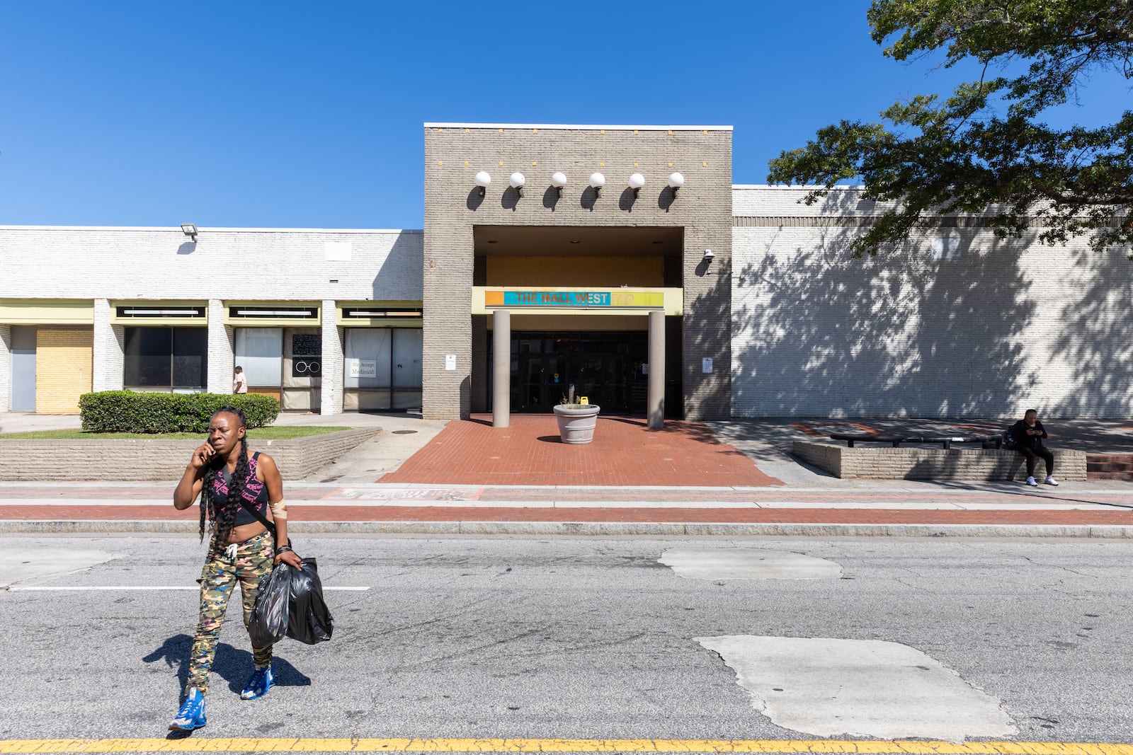 A person leaves the Mall West End in Atlanta on Wednesday, October 2, 2024. The city of Atlanta announced Tuesday that the Mall West End property was acquired as the first step in a massive $450 million project to revitalize the historic site.  (Arvin Temkar / AJC)