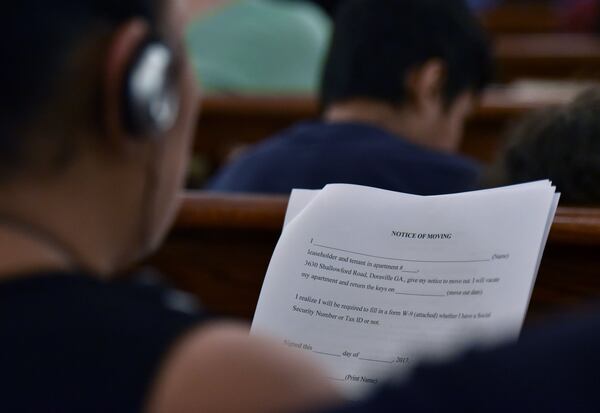 Residents of Shallowford Gardens Apartments use a translation system to listen to John Lantz, manger of the complex, during a meeting with displaced residents at First Baptist Church of Doraville on Wednesday, June 14, 2017. The DeKalb County School District late Monday approved the purchase of the Doraville apartment complex, where they hope to build a new elementary school to alleviate overcrowding in the Cross Keys cluster of schools. The purchase of 3630 Shallowford Road will displace dozens of families in the 104-unit Shallowford Garden Apartments, giving them until the end of August to find new housing. HYOSUB SHIN / HSHIN@AJC.COM