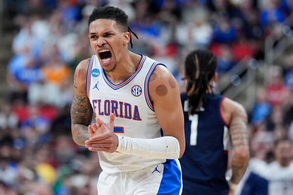 Florida guard Will Richard celebrates after scoring against the UConn during the second half in the second round of the NCAA college basketball tournament, Sunday, March 23, 2025, in Raleigh, N.C. (AP Photo/Chris Carlson)