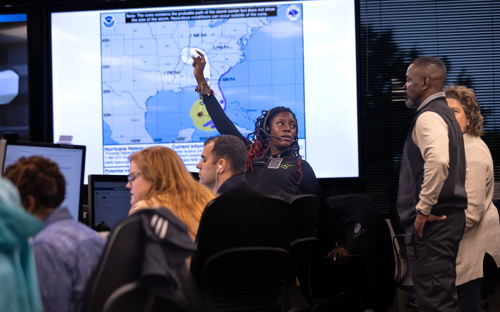 Taronda Gibbons (center) talks with Deputy Regional Administrator, Robert Ashe (right) on Thursday, Sept. 26, 2024 at the FEMA Regional Response Coordination Center in DeKalb County. Helene’s relatively quick forward motion means it’s not likely to weaken as quickly over land as past storms. That means it will still be packing tropical storm-force winds — with even more powerful gusts possible — when it moves past Atlanta. -- (Text by Drew Kann/AJC Photo by John Spink/AJC)