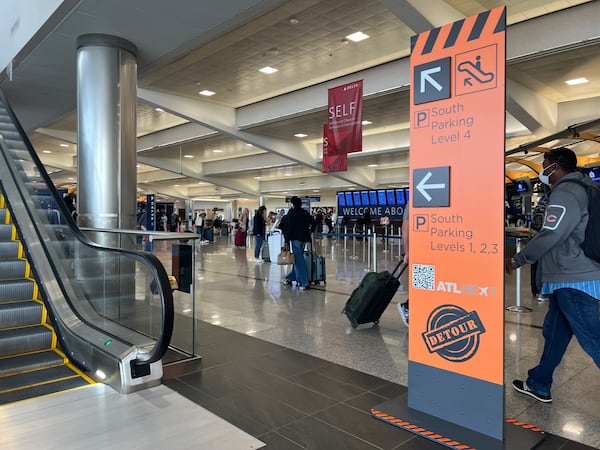 Signs direct people towards detours at Hartsfield-Jackson International Airport during a major parking deck project.