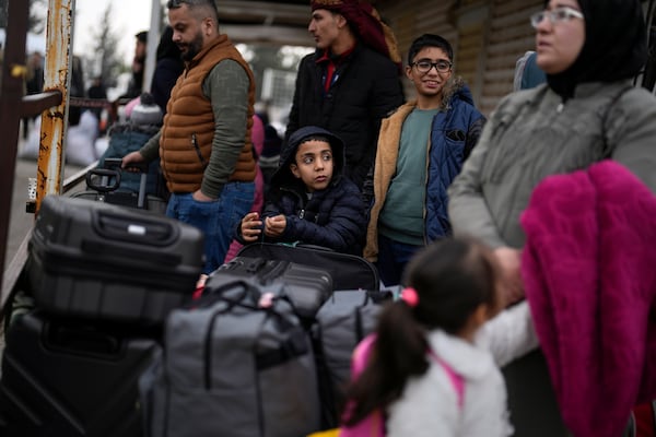 Syrians wait to cross into Syria from Turkey at the Oncupinar border gate, near the town of Kilis, southern Turkey, Thursday, Dec. 12, 2024. (AP Photo/Khalil Hamra)