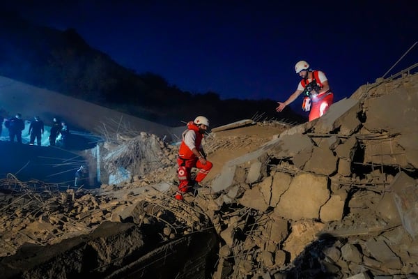 Lebanese Red Cross volunteers and other rescuers search for victims at a house that was hit in an Israeli airstrike in Baalchmay village east of Beirut, Lebanon, Tuesday, Nov. 12, 2024. (AP Photo/Hassan Ammar)