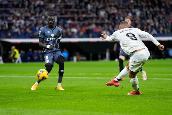 Real Madrid's Kylian Mbappe scores his side's opening goal during the Spanish La Liga soccer match between Real Madrid and Rayo Vallecano at the Santiago Bernabeu stadium in Madrid, Spain, Sunday, March 9, 2025. (AP Photo/Manu Fernandez)