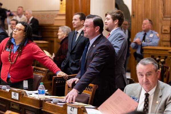 State Sens. Kim Jackson, D-Stone Mountain (left) and Clint Dixon, R-Gwinnett, (center) await voting results on a sports betting bill at the Capitol in Atlanta on Feb. 1, 2024. (Arvin Temkar/arvin.temkar@ajc.com)