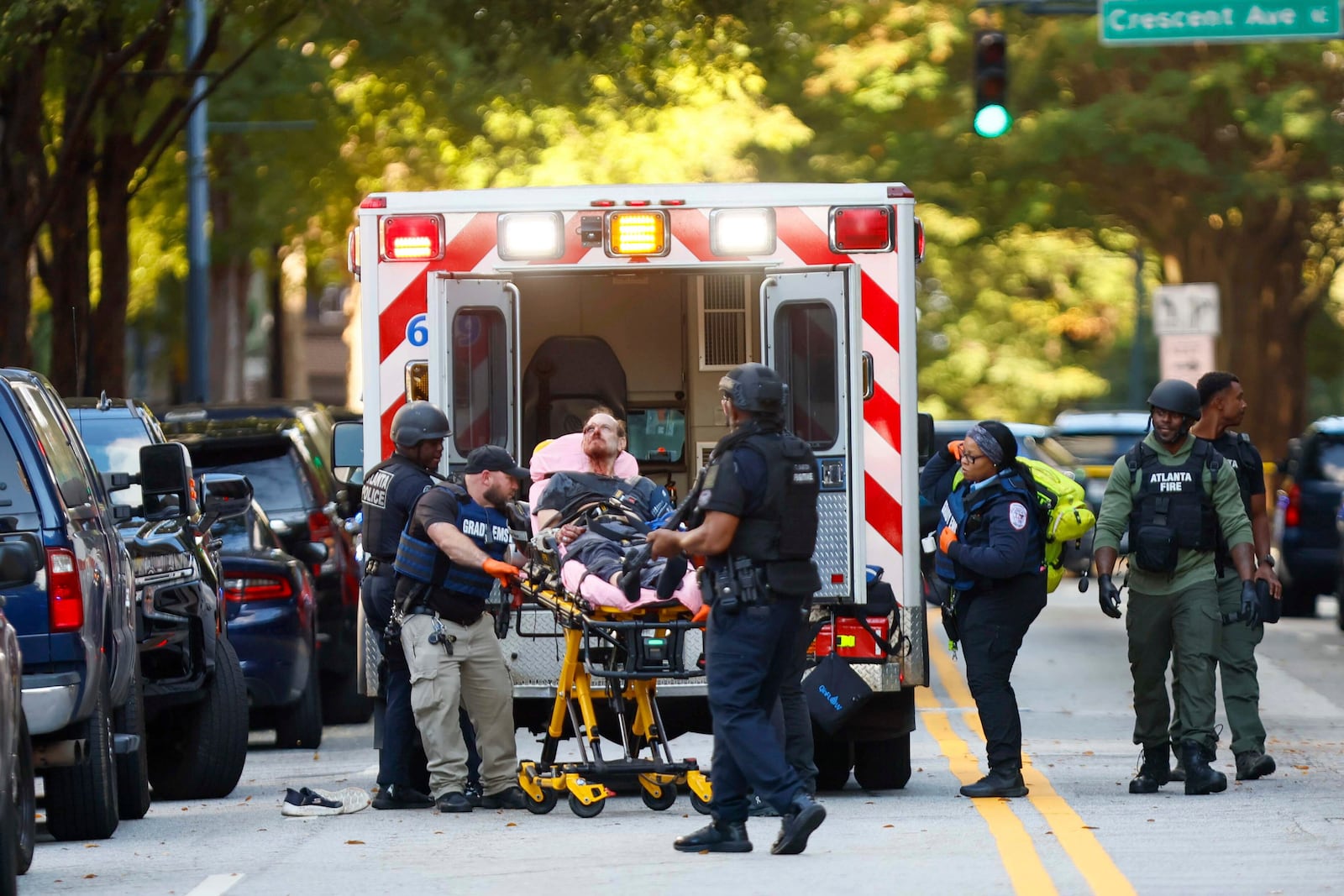 After an hours-long standoff, a suspect is taken into custody with visible injuries on 14th Street outside the Four Seasons Hotel after gunshots were reported in the Midtown neighborhood of Atlanta, Tuesday, Oct. 29, 2024. (Miguel Martinez/Atlanta Journal-Constitution via AP)