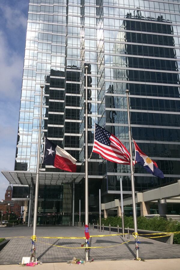 The U.S. flag, Texas state flag and City of Dallas flag all fly at half-staff near the shooting site. Photo: Jennifer Brett