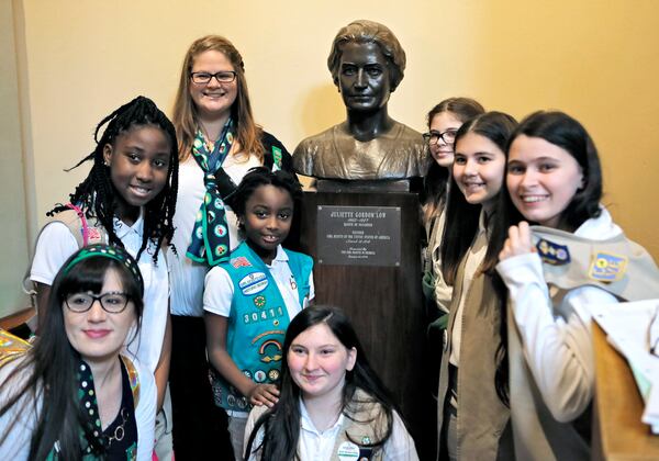 Girl Scouts from Savannah gather for a group photo around the bust of Juliette Gordon Low, their organization’s founder, just outside the House chamber. BOB ANDRES /BANDRES@AJC.COM