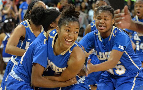 February 28, 2015 Atlanta - McEachern's Te'a Cooper (2) is celebrated by teammates after she scored the game wining goal to beat 59-57 over Archer at the end of 4th quarter at McCamish Pavilion in Georgia Tech campus on Saturday, February 28, 2015. McEachern defeated Archer 59-57 in the Class AAAAAA high school basketball tournament. HYOSUB SHIN / HSHIN@AJC.COM McEachern's Te'a Cooper (2) is celebrated by teammates after she scored the game-wining shot in the Class AAAAAA tournament. (Hyosub Shim / AJC)