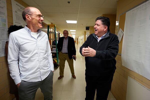 Illinois Gov. JB Pritzker, right, talks with Dr. Peter Goldsmith, Director of Soybean Innovation Lab, during visit at the University of Illinois's National Soybean Research Laboratory in Urbana, Ill., Wednesday, March 19, 2025. (AP Photo/Nam Y. Huh)