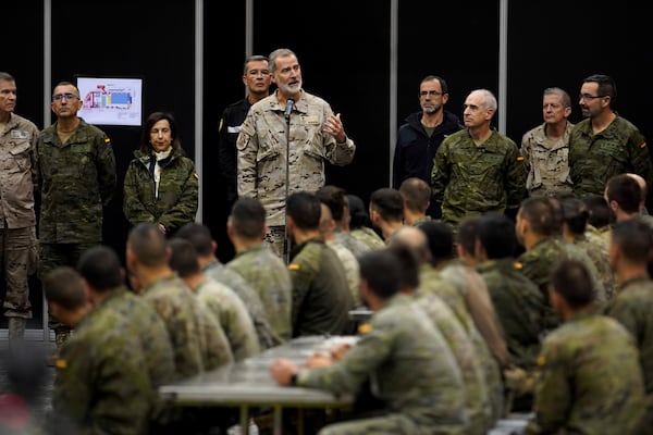 Spain's King Felipe VI, speaks to the troops as he visits a military base on the outskirts of Valencia after floods left hundreds dead or missing in the Valencia region in Spain, Tuesday, Nov. 12, 2024. (AP Photo/Alberto Saiz)