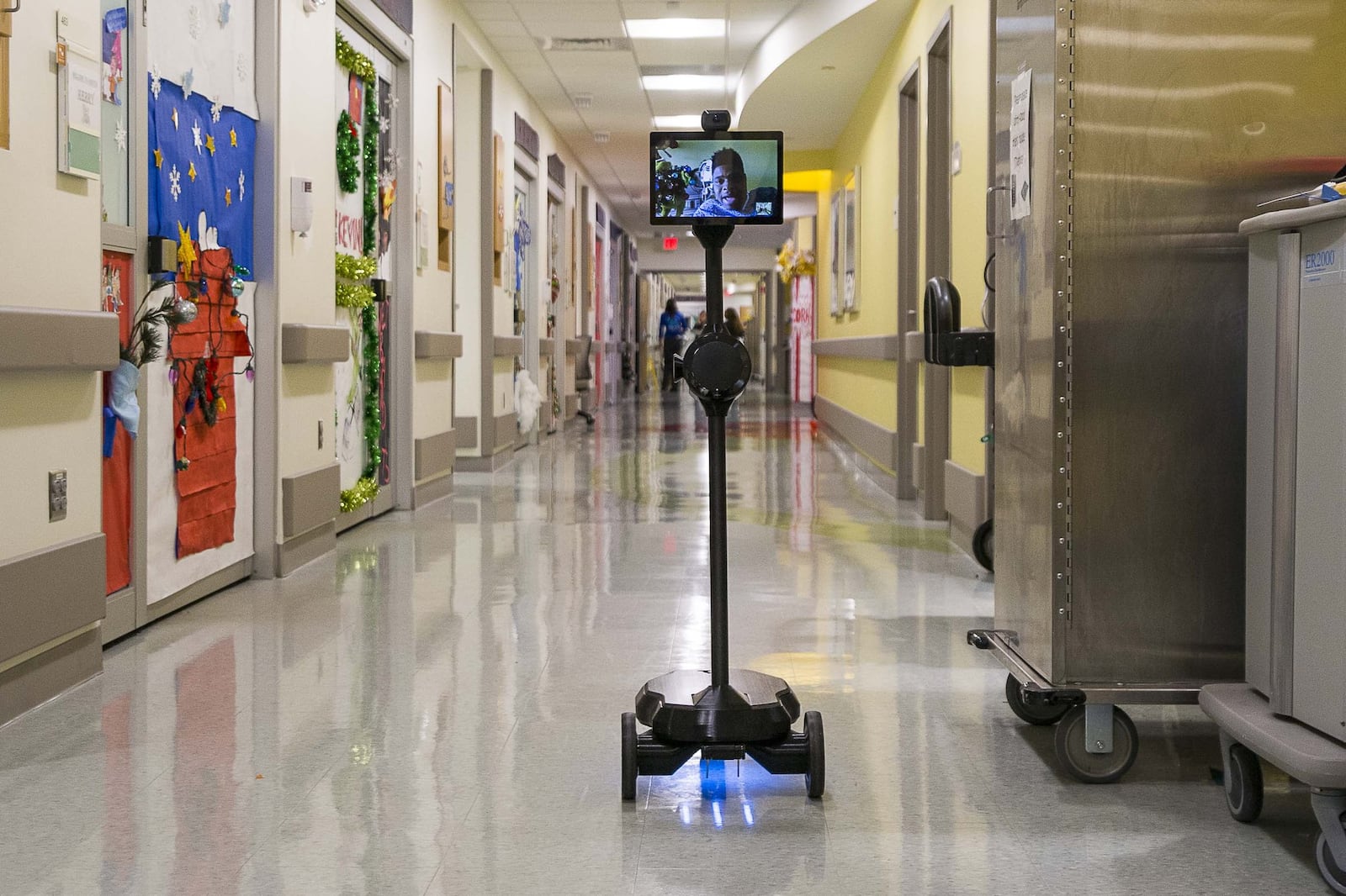 Patient Steffon Boyd’s, 17, face is displayed on a screen attached to an OhmniLabs robot as he roams the hallway outside of his hospital room at the Children’s Healthcare of Atlanta at Scottish Rite on Dec. 19, 2019. (ALYSSA POINTER/ALYSSA.POINTER@AJC.COM)