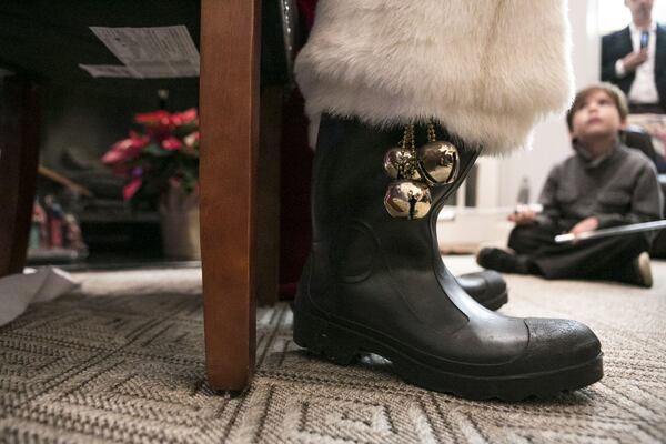 Bells are seen on the boots of Judge T. Jackson Bedford, as he performs magic tricks for children at a house Christmas party in Smyrna. CASEY SYKES / FOR THE ATLANTA JOURNAL-CONSTITUTION