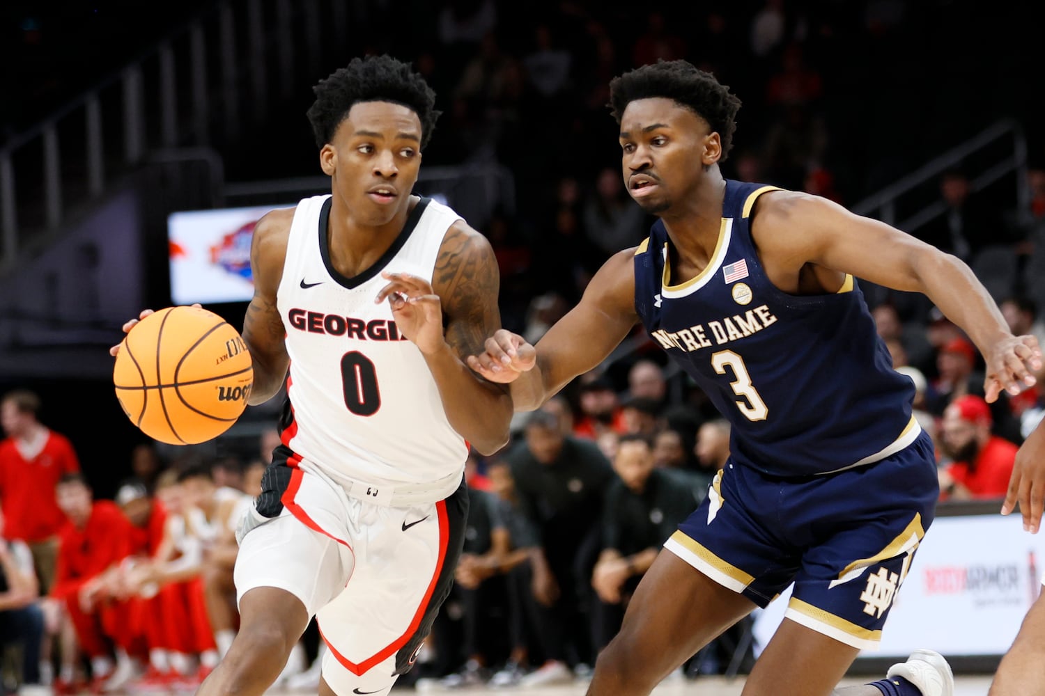 Bulldogs guard Terry Roberts drives against Fighting Irish guard Trey Wertz during the first half Sunday night at State Farm Arena. (Miguel Martinez / miguel.martinezjimenez@ajc.com)