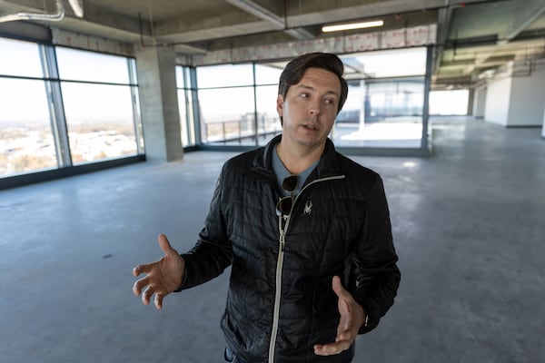 Travis Garland, managing director of Portman Holdings, gives a tour of newly completed office tower Spring Quarter in Atlanta on Monday. Arvin Temkar/AJC