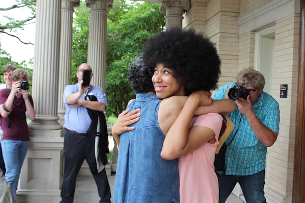 Mariah Parker hugs her mother Mattie Parker, after the 26-year-old was sworn in as an Athens-Clarke County Commissioner.