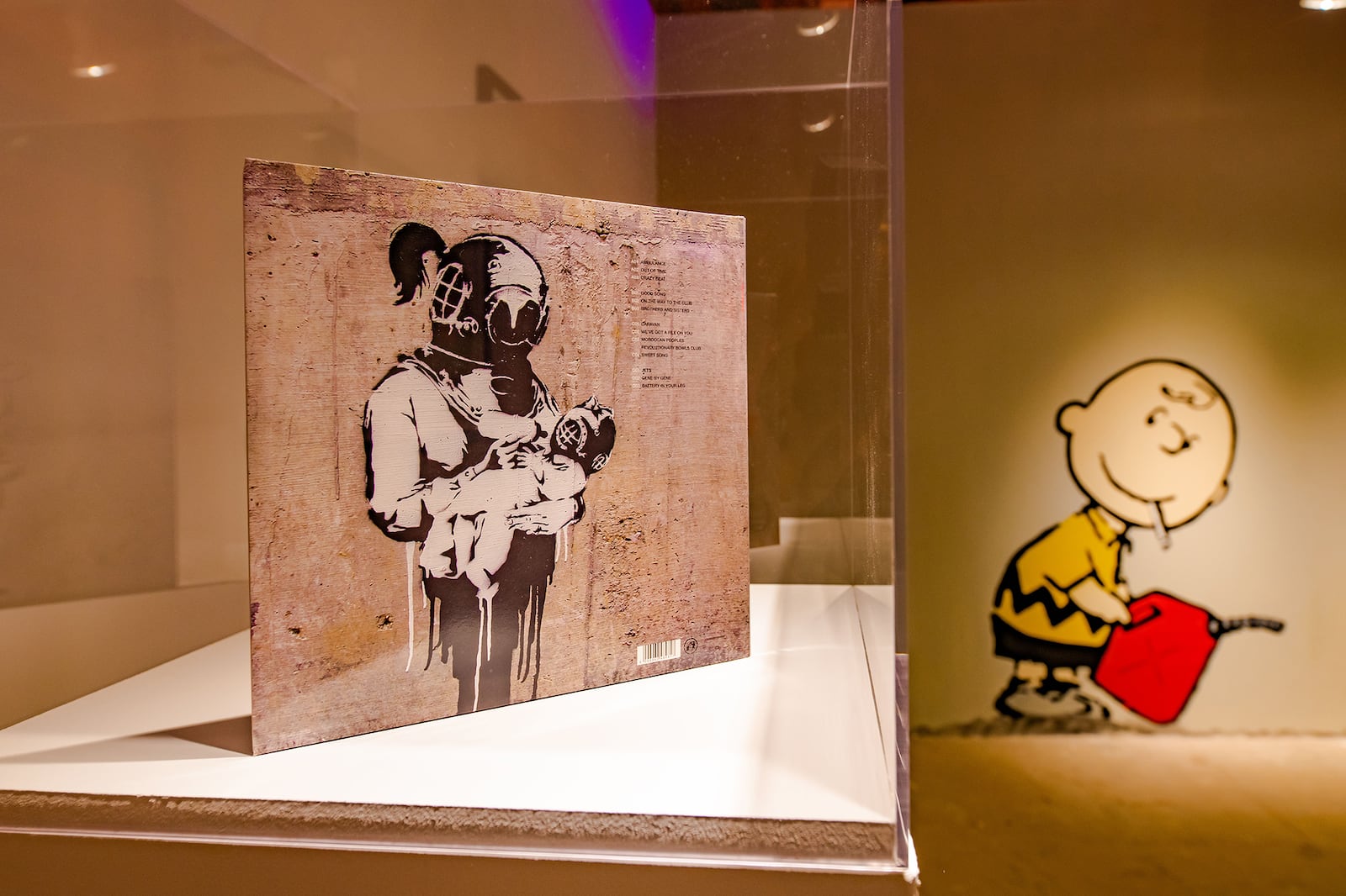 Banksy designed the 2003 Blur record album for "Think Tank," on display in "Without Limits" alongside a mural (seen in the background) in the Banksy mode recreated by local artists.
Courtesy of Lola Scott Art for SEE Global Entertainment.