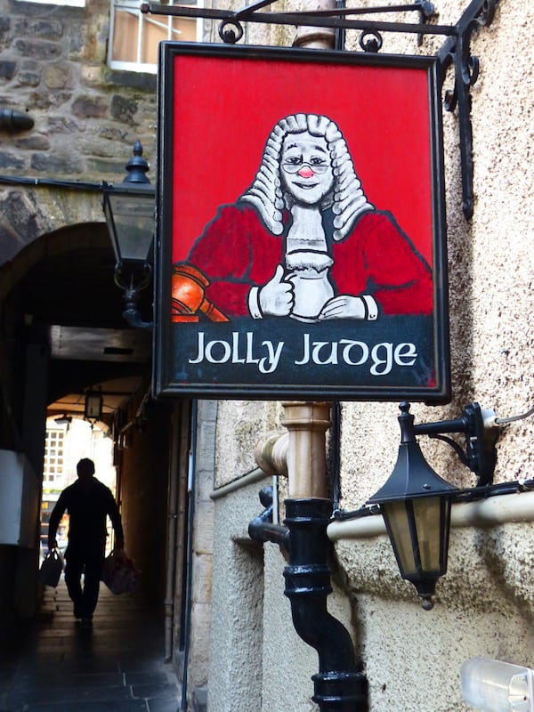 A sign marks Edinburgh's Jolly Judge Pub, off James Court Close. The cozy basement pub was in business in 1786 when the poet Robert Burns lived in nearby Baxter's Close (Brian J. Cantwell/The Seattle Times/TNS)